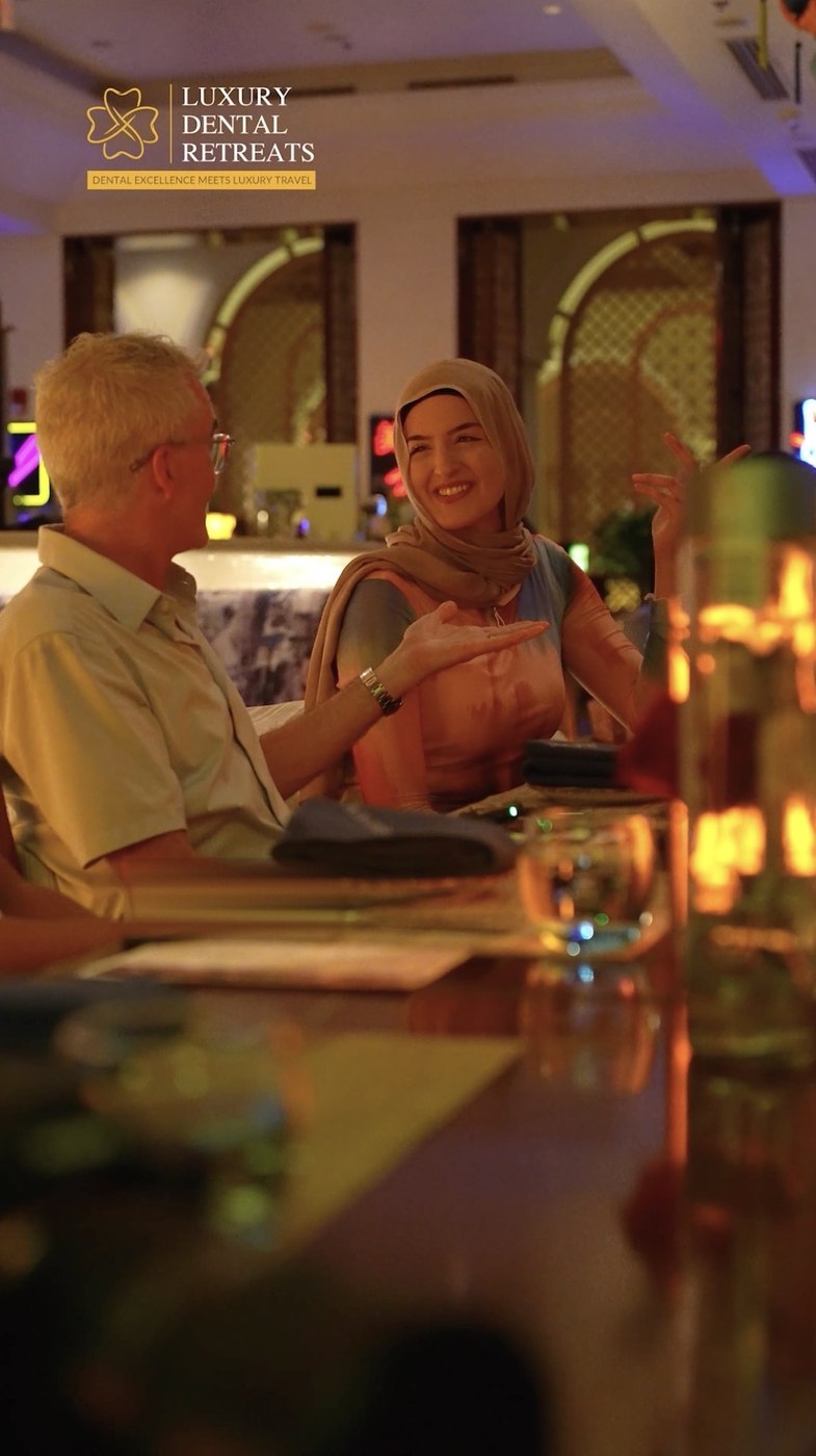 Jim Arnold in conversation with a retreat attendee at an evening venue in Dubai