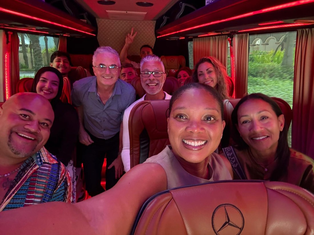 Group photo aboard the coach between venues